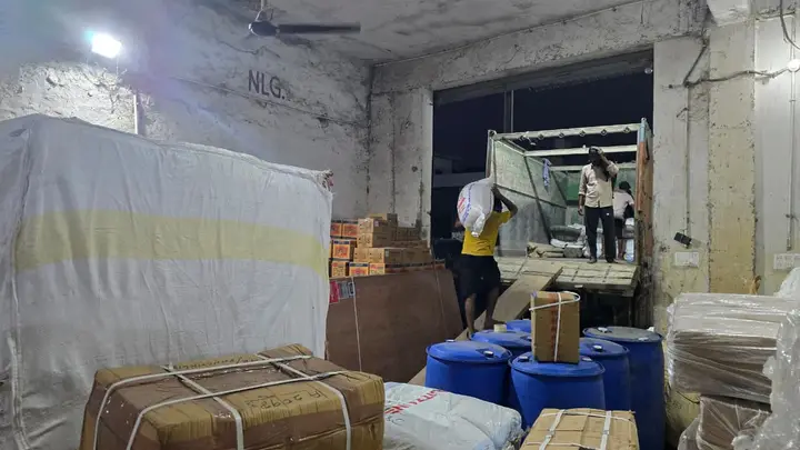 Consignments being unloaded at the goods carrier godown